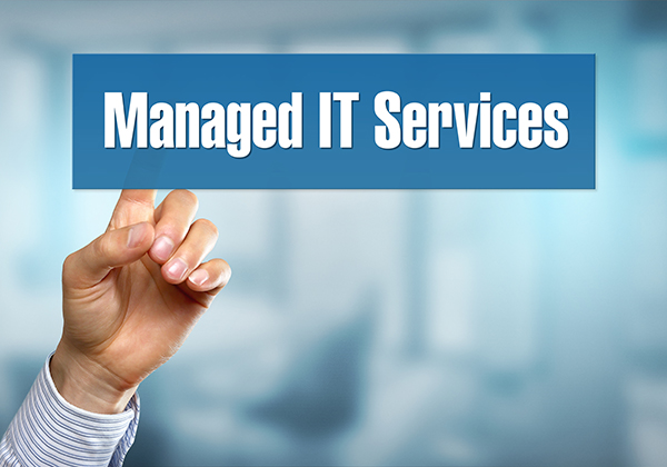 An image of a hand pointing to a blue sign that says “Managed IT Services” in white text