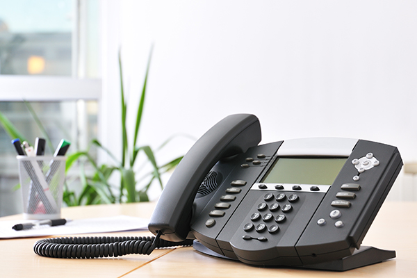 A VOIP phone system on a black and silver phone.