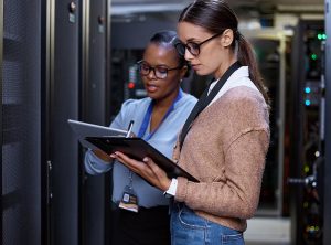 two women consulting in a server room